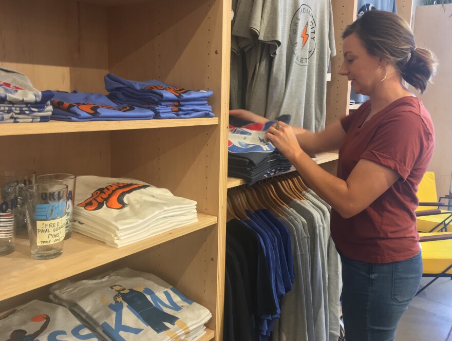 Owner Audrey Falk looks through Thunder t-shirts at Shop Good in Oklahoma City.