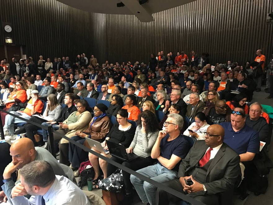 The council meeting room was packed with a lively crowd, the vast majority of whom erupted in applause when the votes came through.
