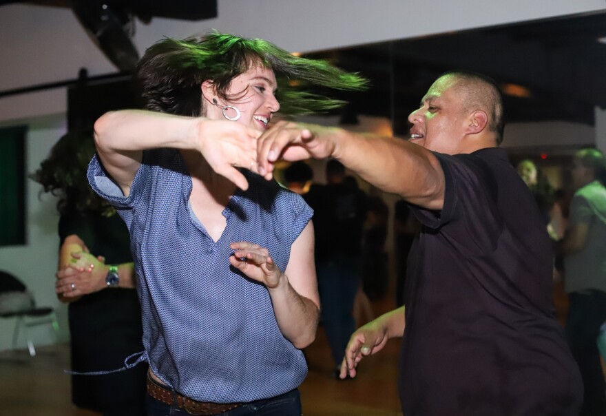 Dancers perform to a salsa music at Convergence Dance and Body Center on October 19, 2019.