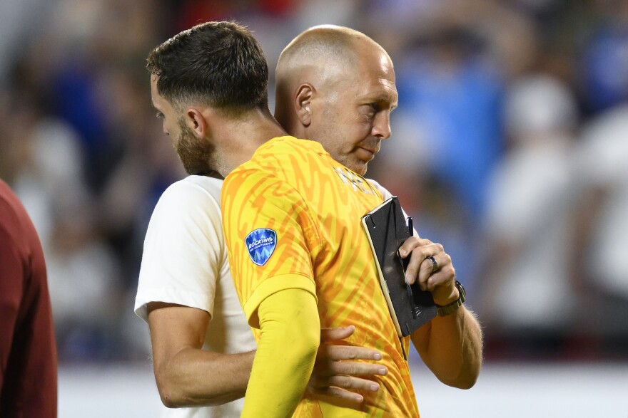 Coach Gregg Berhalter of the United States greets goalkeeper Matt Turner after losing 0-1 against Uruguay at the end of a Copa America Group C soccer match in Kansas City, Mo., Monday, July 1, 2024. (AP Photo/Reed Hoffman)