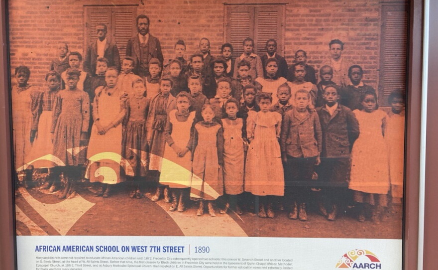 A poster on the side of the new African American Heritage Center, depicting students from an African American school on W. 7th St., circa 1890.