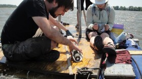 Geologists from the University of Wisconsin extrude a 6-meter sediment core from the deepest point of Horseshoe Lake. 