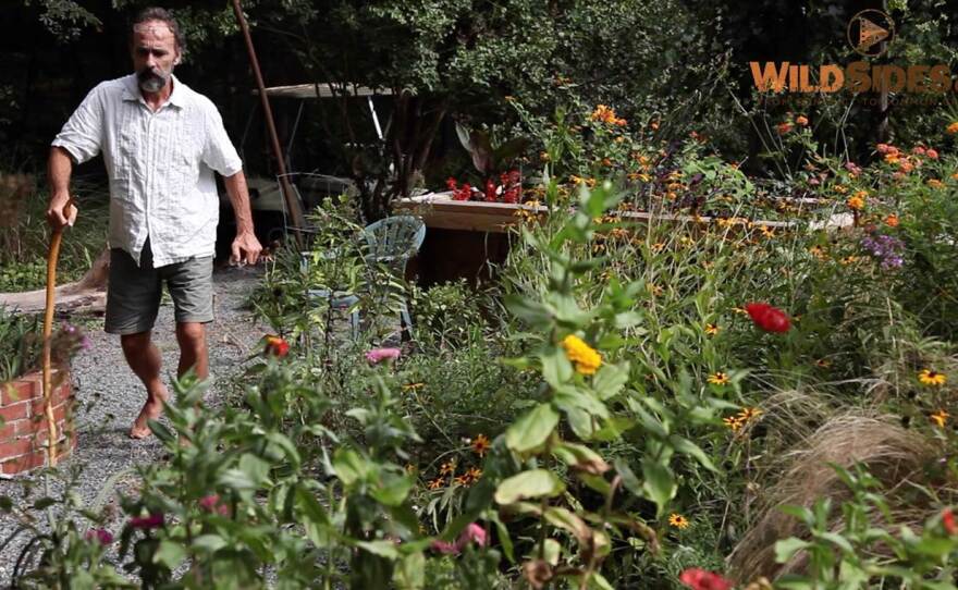 Photo of Chris Lucash walking with a cane