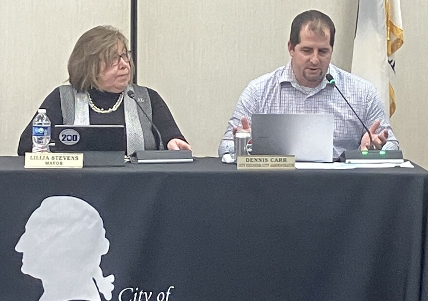 Dennis Carr, who has served as Washington's interim city administrator since May, answers a question during Monday's Washington City Council meeting while Mayor Lilija Stevens listens.