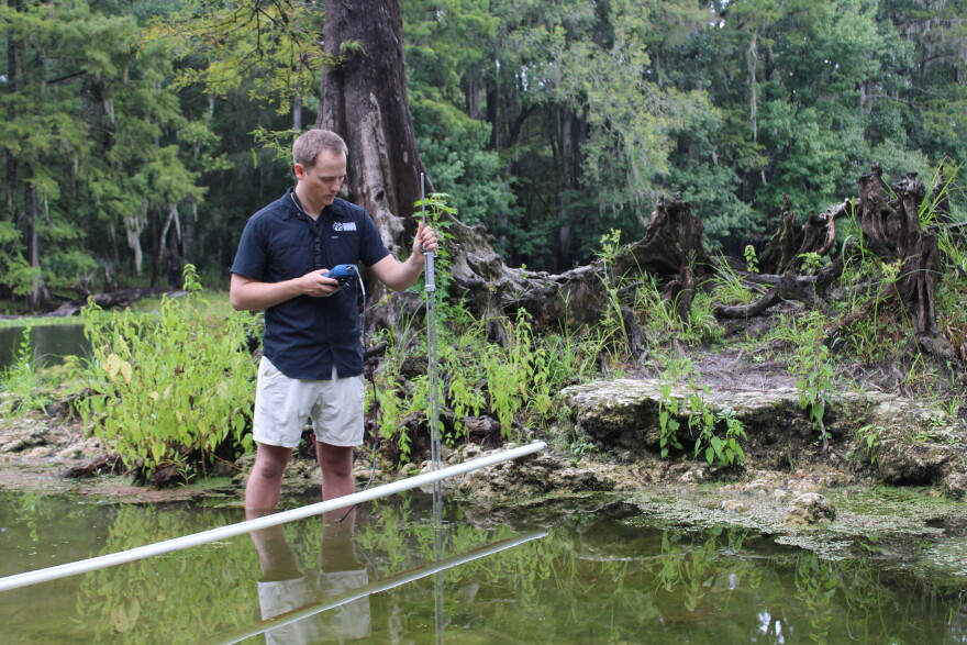 Environmental scientist Bill Hawthorne measures water velocity in the Poe Spring run.