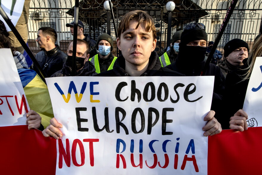 People hold signs and chant slogans during a protest outside the Russian Embassy on February 22, 2022 in Kyiv, Ukraine. After Russian forces concluded large-scale military exercises in Belarus amid a tense diplomatic standoff between Russia and Ukraine's Western allies, Russian President Vladimir Putin in a nation wide televised statement, recognized the independence of two breakaway regions in Eastern Ukraine and has since sent Russian "peacekeepers" to the area raising fears of a full-scale invasion.