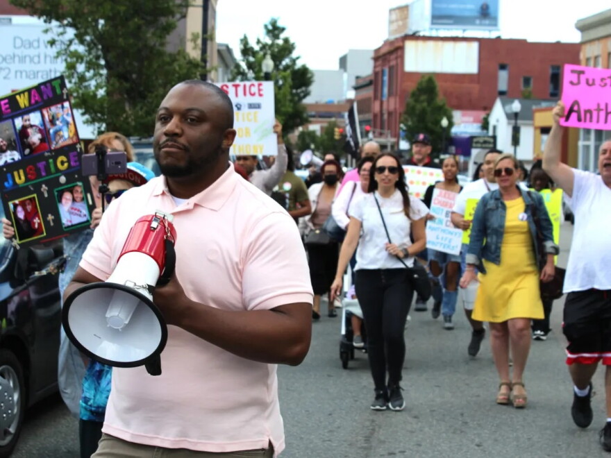 Anthony Harden's brother, Carl Harden, leads a crowd of protesters down South Main Street in Fall River in June 2022.
