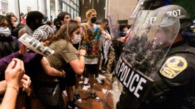 Sereen Haddad stands and other protesters clash with police on Monday, April 29, 2024 at VCU in Richmond. (Photo by Shaban Athuman, VPM News)