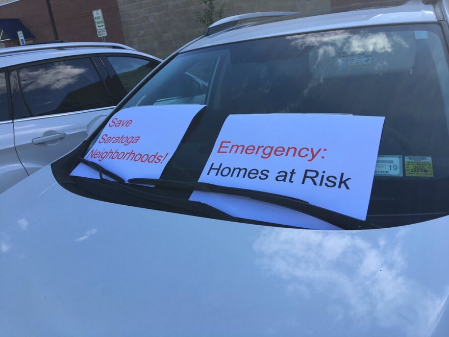 Signs on a car outside a Saratoga Springs Planning Board meeting