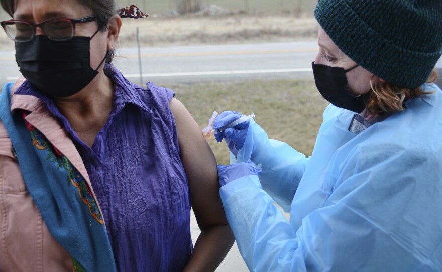 Sherry Cross Child, a Canadian resident of Stand Off, Alberta, receives a COVID-19 vaccine at the Piegan-Carway border crossing near Babb, Mont., on April 29. The Blackfeet tribe in northern Montana gave out surplus vaccines in April to its First Nations relatives and other residents from across the border.