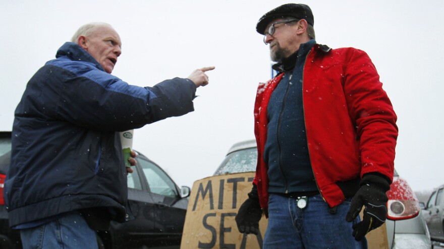 Chris McDonough, a Republican (left), and Robert O'Brien, a Democrat, argue about political issues outside a caucus in Portland, Maine, in February.