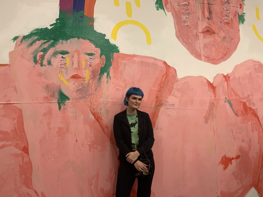 Artist Nina Kersey in front of her installation in the KMAC first floor lobby