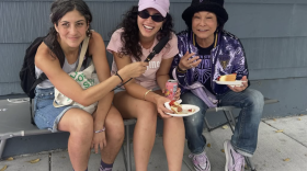 KALW News chats with Valkyries fans, including Lillian Shiiba (far right) wearing a sparkly violet jacket and GSV bucket hat before Game 1 of the WNBA semi-finals on October 4, 2026.