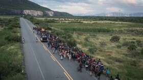 A caravan of migrants escorted by police officers advances along the route between the towns of La Venta and Juchitán, in southern Mexico.