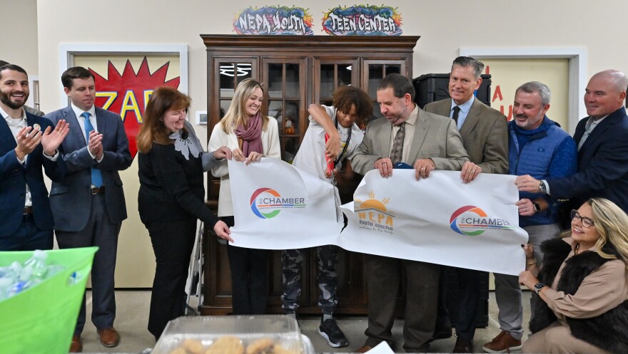 Volunteer Anthony Pauline cuts the ribbon at the Oct. 16, 2025, grand opening of the NEPA Youth Shelter's new teen center on Providence Road in Scranton.
