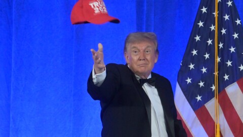 President Donald Trump tosses a "Trump 2028" hat at the White House Correspondents' Association dinner at the Waldorf Astoria Washington DC, Friday, July 24, 2026, in Washington. (AP Photo/Rod Lamkey, Jr.)