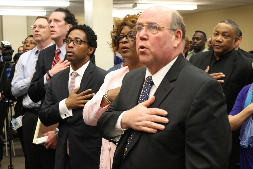 Former Ferguson Brian Fletcher says the Pledge of Alligence before being inaugurated as a Ferguson City Councilmember last April. Fletcher died on Sunday at the age of 56.