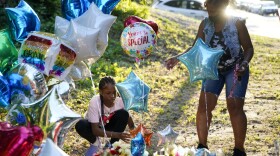 Debbie Jamison, right, with her daughter Precious, 12, leave balloons at a memorial for Cyrus Carmack-Belton, Friday, June 2, 2023, in Columbia, S.C. Authorities said Carmack-Belton, 14, was shot and killed by a store owner who wrongly suspected him of shoplifting. (AP Photo/Erik Verduzco)