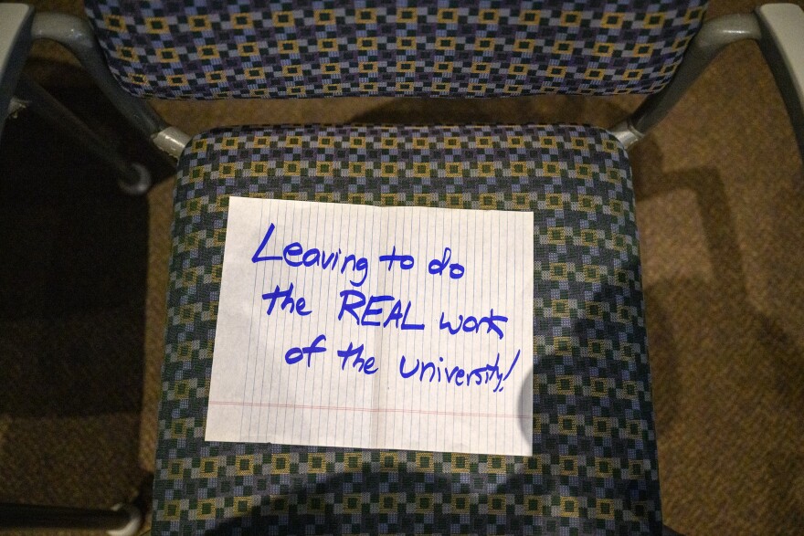 An unoccupied chair holds a note left by an attendee to a meeting of the Board of Regents of the Connecticut State Colleges and Universities November 15, 2023.