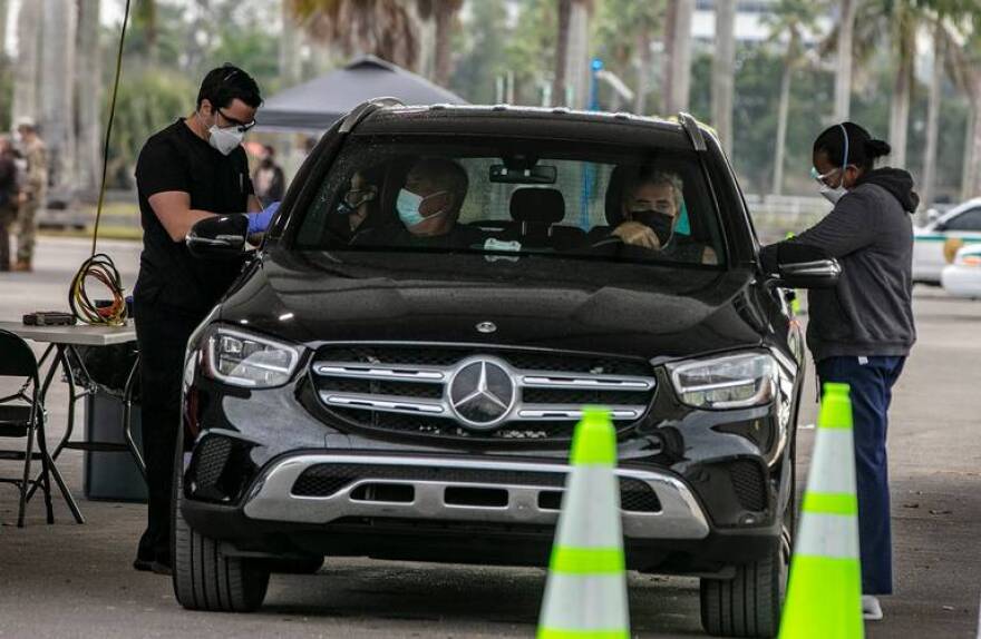 Nurses give the COVID-19 vaccine to Miami-Dade County residents with appointments at the Tropical Park site in Miami on Wednesday, Jan. 13, 2021.