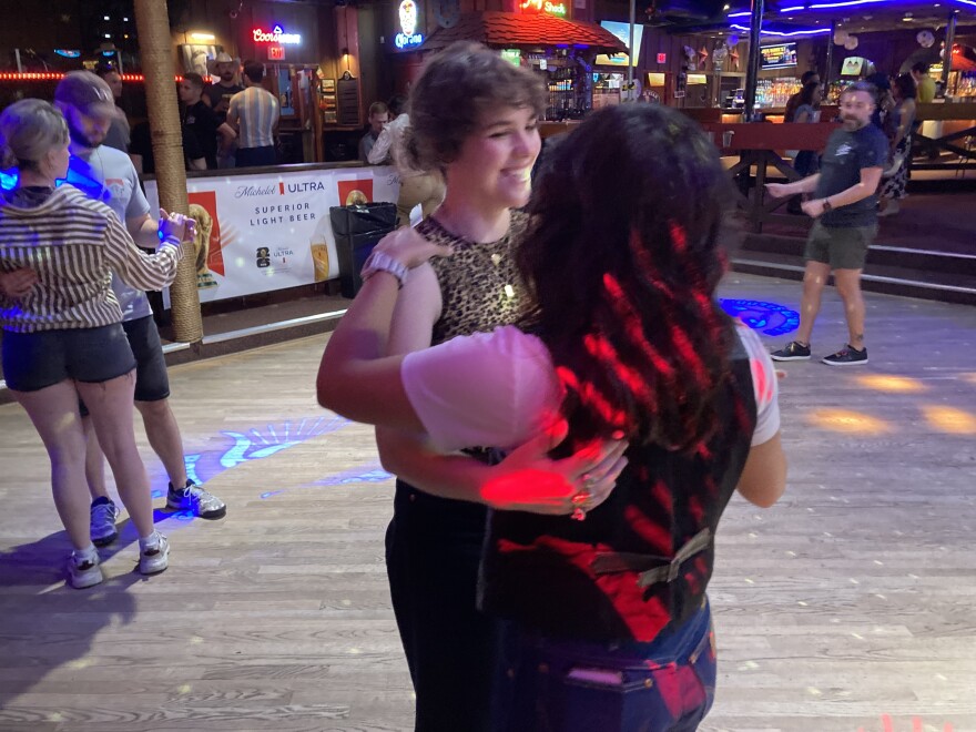 KERA's Alexsis Jones learns how to two-step with her girlfriend, Criselle Velasco, at Round-Up Saloon in Dallas.