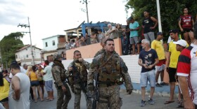 Police officers stand walk near former lawmaker Roberto Jefferson´s home in Levy Gasparian, Rio de Janeiro state, Brazil, Sunday, Oct. 23, 2022. Jefferson, an ally of Brazilian President Jair Bolsonaro, fired gunshots and a grenade at federal policemen who tried to arrest him in for insulting supreme court ministers, according to Brazil’s federal police.