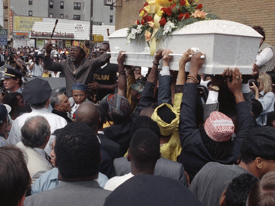 A crowd of mourners gathers outside St. Anthony's Baptist Church in Brooklyn, N.Y., on Aug. 27, 1991 as the casket carrying the body of Gavin Cato passes by.