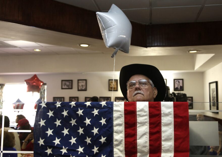 Cuban American Rene Espinosa watches a televised broadcast of the presidential inauguration of Donald Trump, Friday, Jan. 20, 2017, during a watch party organized by Hispanas for Trump, in Miami. (AP Photo/Lynne Sladky)