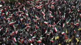 Demonstrators wave Iranian flags in a demonstration in support of the government and against U.S. and Israeli strikes in Tehran, Iran, Saturday, Feb. 28, 2026.