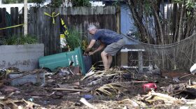 A Cedar Key, Florida, business owner clears debris outside his office after Hurricane Hermine. The hurricane was downgraded to a tropical storm after it made landfall in Florida and, now off the Northeast coast, is expected to weaken. (AP Photo/John Raoux)