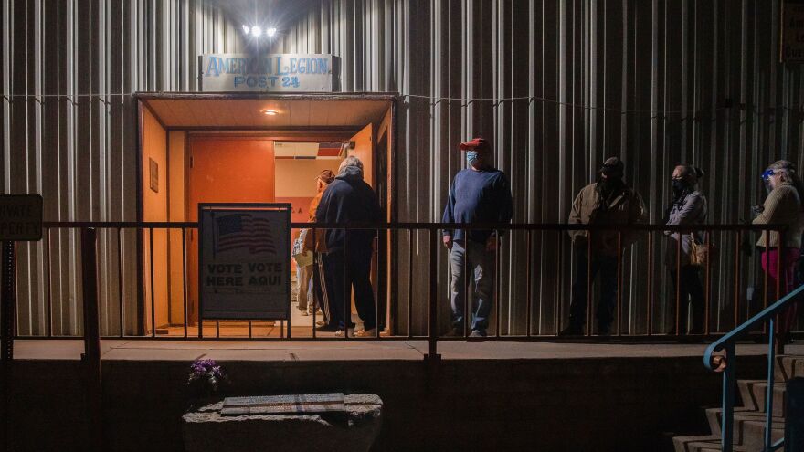People wait in line to vote in the early morning in front of the American Legion in Tombstone, Ariz., on Nov. 3, 2020.