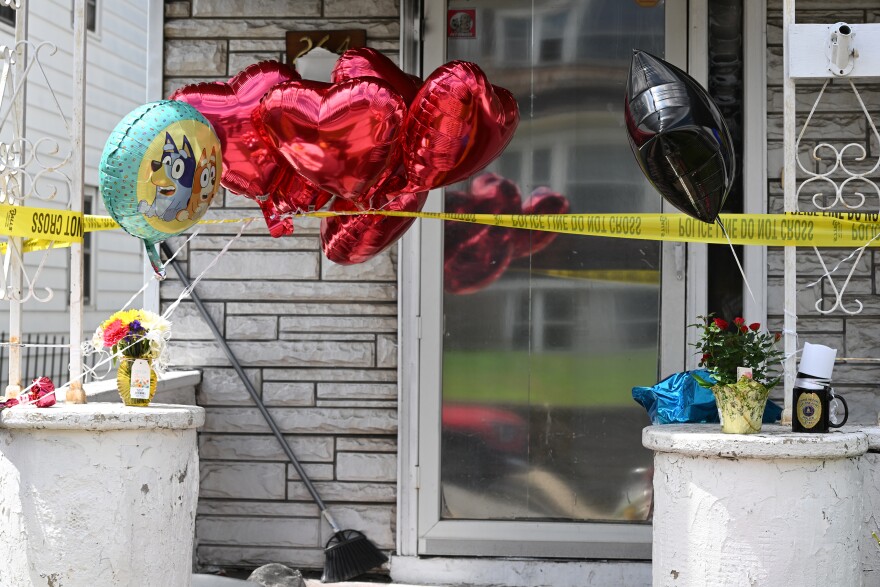 Balloons are left outside the Bennett street home where a 15 year-old boy lost his life in a fire. the police officer that came upon the fire left a mug at the house.