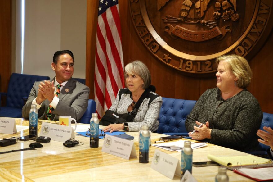 From left to right: New Mexico Lt. Gov. Howie Morales, Gov. Michelle Lujan Grisham and Early Childhood Education and Care Department Secretary Elizabeth Groginsky, pictured at a Sept. 8, 2025, news conference announcing the state’s universal childcare program. (Source NM file photo)