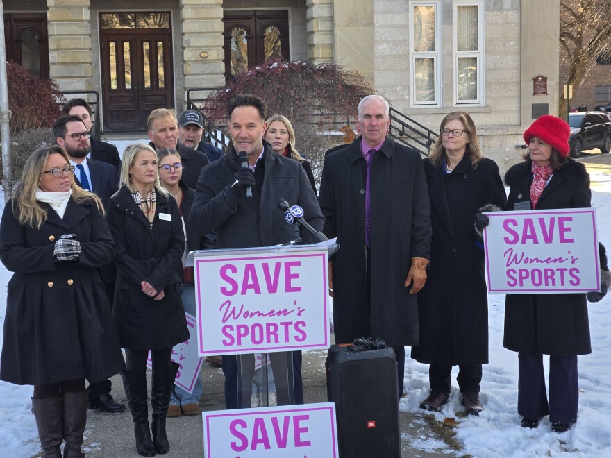 Monroe Public Schools parent Sean Lechner addresses a crowd during a press conference over his Title IX complaint.