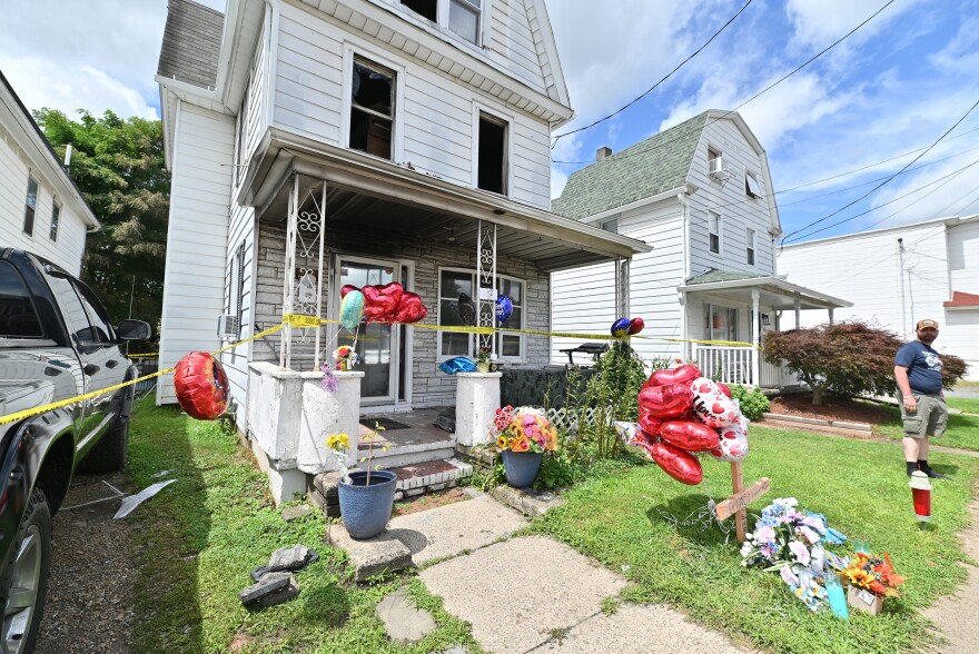 Neighbor Jay Conden stands at the home on Bennett Street in Luzerne Borough where a fatal fire claimed the life of a 15-year-old boy and injured three members of his family. 