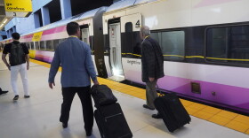Passengers walk to board a Brightline train in Miami. Brightline first began running its trains between Miami and Orlando in 2023. The company began running its neon-yellow trains between Miami and West Palm Beach in 2018.