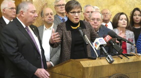 Kansas Gov. Laura Kelly, center, answers questions from reporters about a new Medicaid expansion plan as lawmakers and other advocates watch during a news conference in Topeka, Kansas. (John Hanna/AP)