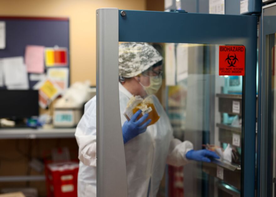 NCH lab technician handling plasma used for the treatment of critically ill patients with COVID-19.