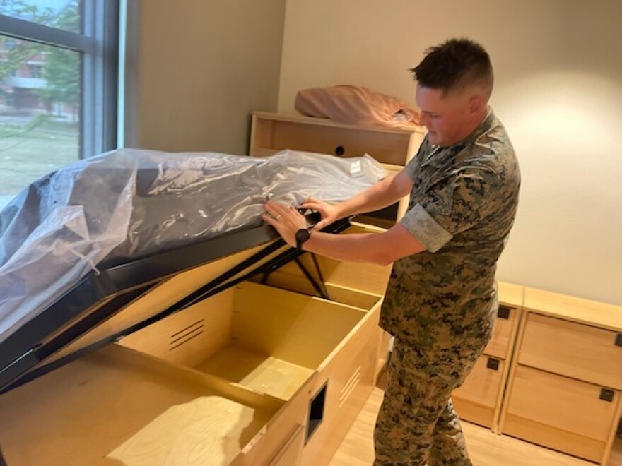 Lt. Thomas Garbee shows the new barracks at Naval Weapons Station Yorktown in Virginia. The Marine Corps is continuing to build and operate its own barracks, while other service branches are embracing privatization.