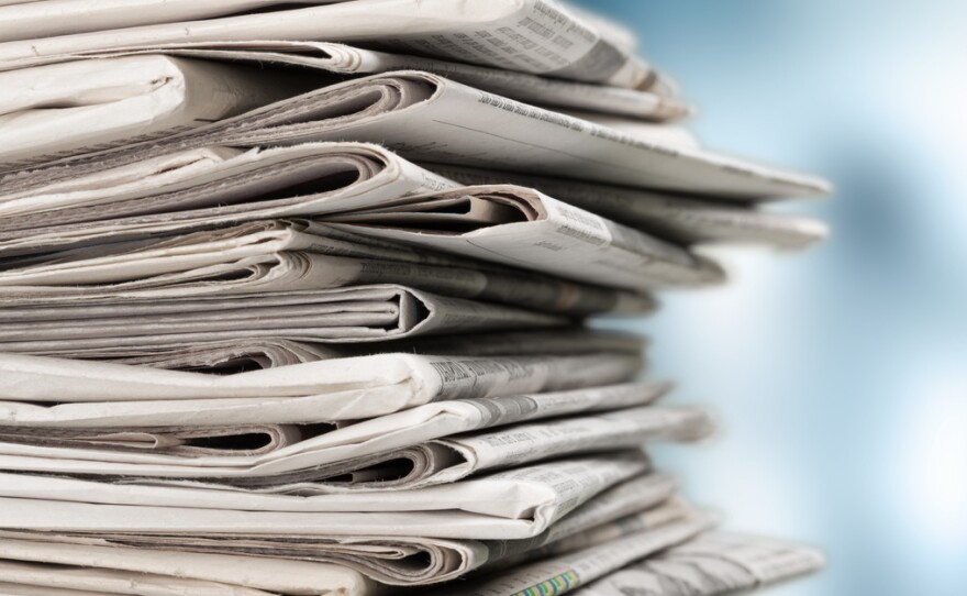 Pile of newspapers on white background