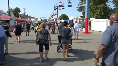 People walk down the midway on opening day of the Ohio State Fair in 2019.