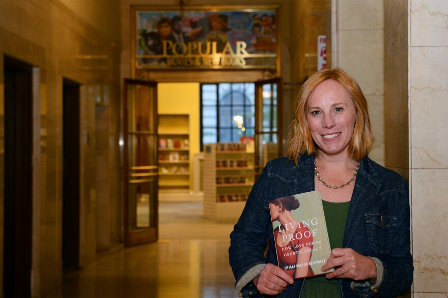 Tiffany Graham Charkosky holds her memoir for a portrait
