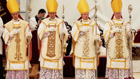 Newly consecrated bishops, from left, Marc Hanappier, Michel Poinsinet de Sivry, Michael Goldade and Pascal Schreiber wearing their miters and holding their pastoral staffs, stand at the end of their consecration ceremony in a tent set up outside the Society of St. Pius X seminary in Econe, Switzerland, Wednesday, July 1, 2026.