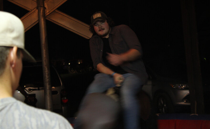Southern Retreat frontman Skylar Schutz rides a mechanical bull.