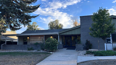 A green and grey home with the number "811" on the outside. 