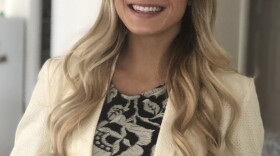 Alli Warner is looking at the camera and smiling.