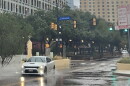 A car splashes its way down Houston Street downtown on Oct. 1, 2026