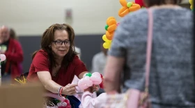 The Balloon Twister vendor Stephanie Neal puts a flower bracelet made out of balloons around a child’s wrist during the annual Spring Craft Fair April 18. Neal charged 50 cents per balloon used to ensure every child had the opportunity to get one.