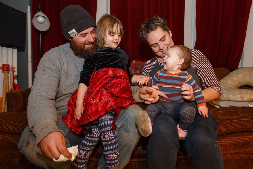 The Siebers family, now relaxed, on the living room couch that limited their world for several months when Margaret was on bed rest. Today both parents have returned to full-time paid work.