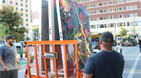AJ Rose (left) and Jael Sundown start to unload murals for their installation